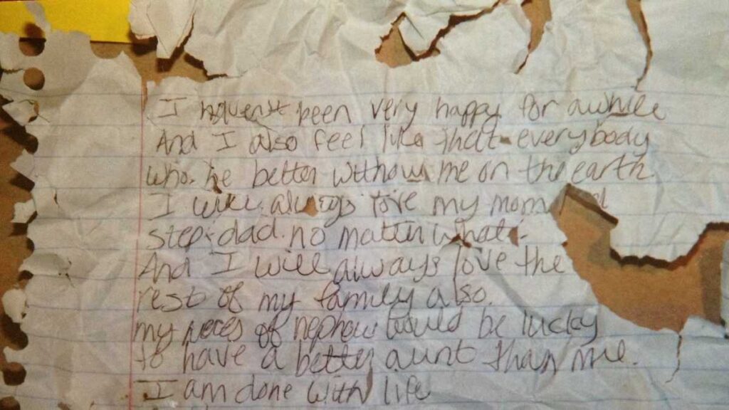 Photo of the tattered suicide note the killers forced Jennifer Daugherty to write.