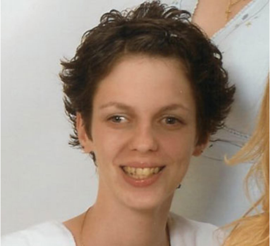 Photograph of Jennifer Daugherty wearing white and smiling.