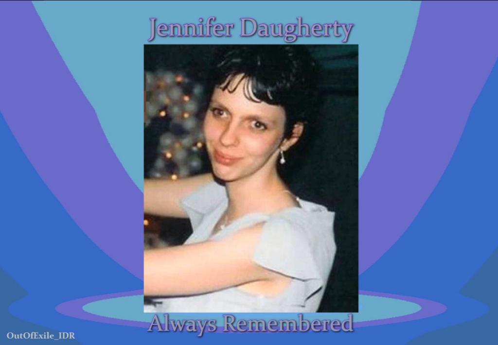 Image is a photo of Jennifer Daugherty on a background of lavender and pastel blues. Below the photo is what appears to be a platform where the photo rests. Jennifer is smiling as she is dancing at an event. Text outlined in lavender reads: Jennifer Daugherty. Always remembered.